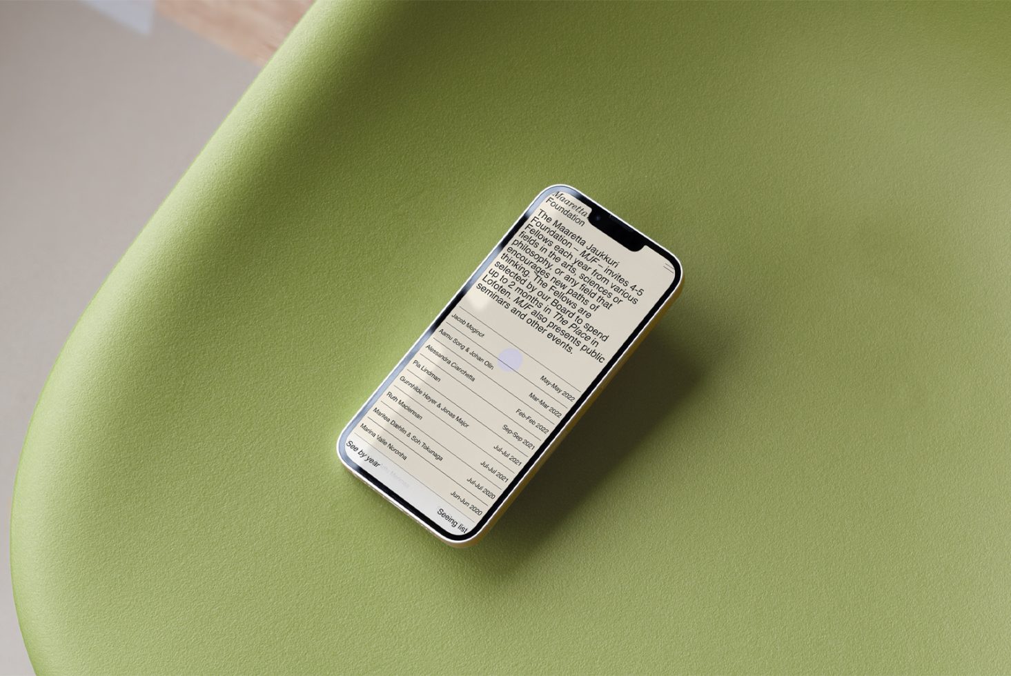 Smartphone on green surface displaying text interface mockup, ideal for showcasing app designs and responsive templates for designers.